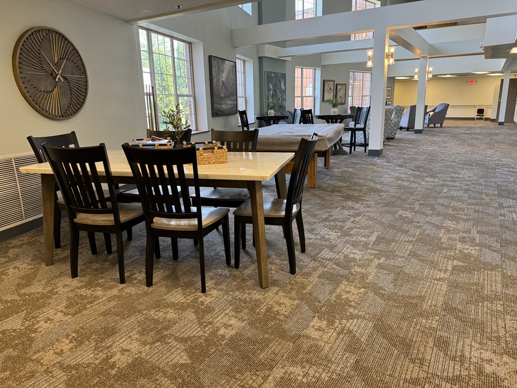 a large dining room with tables and chairs in a building
