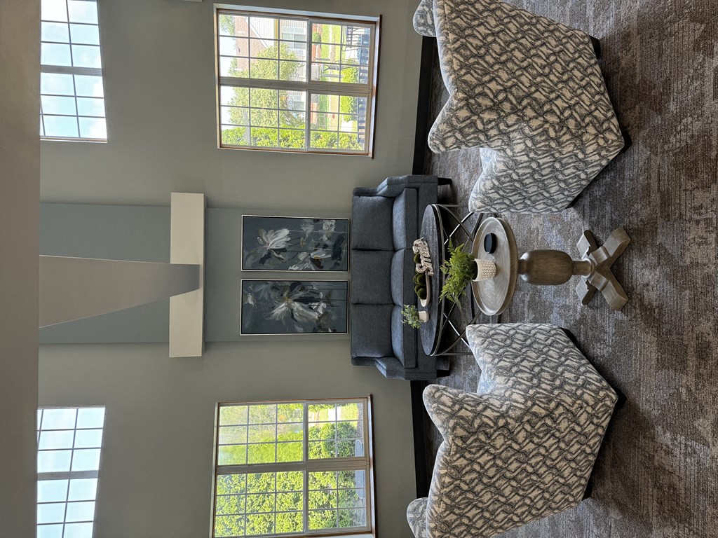 a view from above of a living room with couches and a table and windows