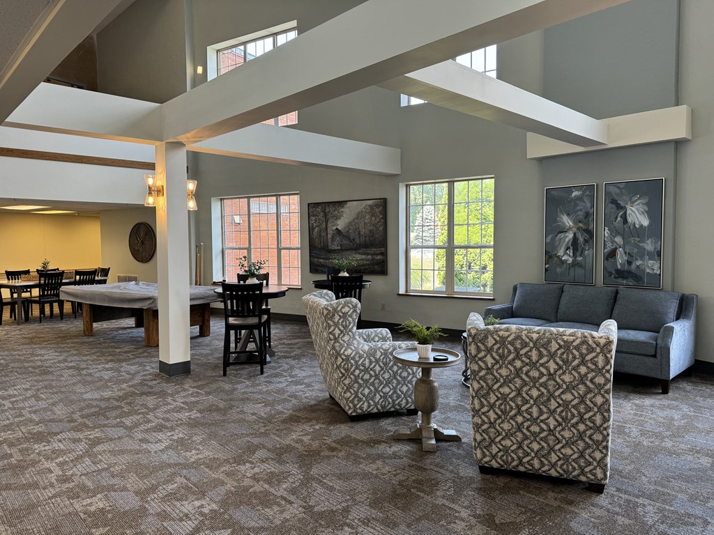 a large living room with couches and chairs and a dining table
