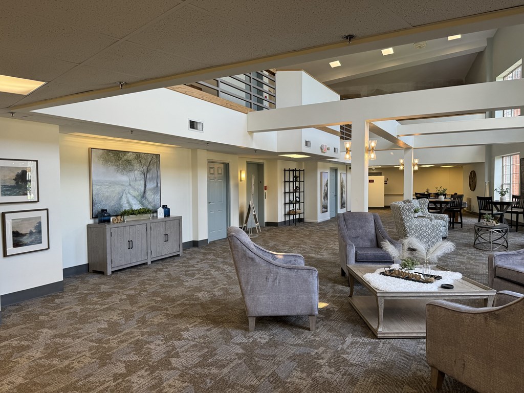 a lobby with couches and chairs and a coffee table