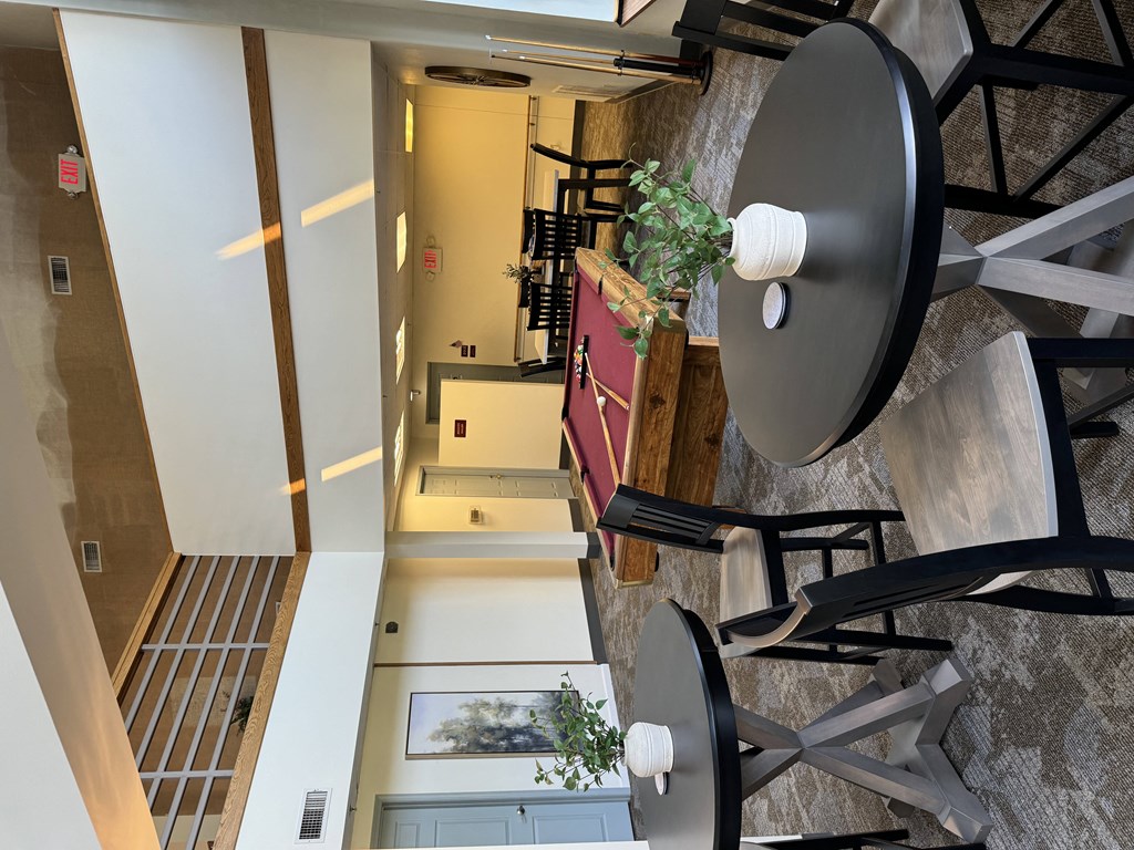 a view from the top of a staircase looking down into a living room with a