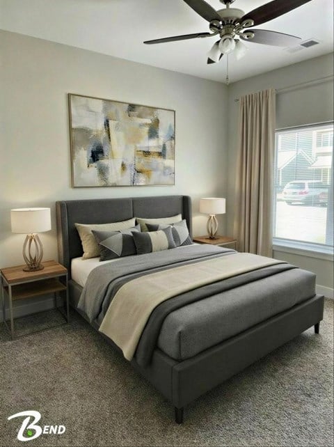 A bedroom with a large bed and a ceiling fan.