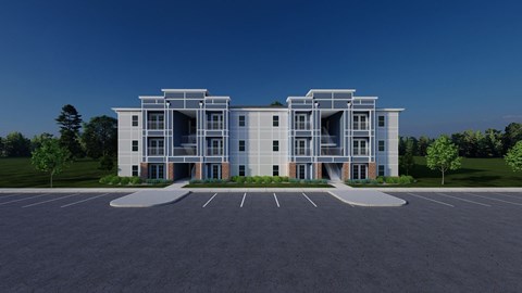 A modern building with a parking lot in front.