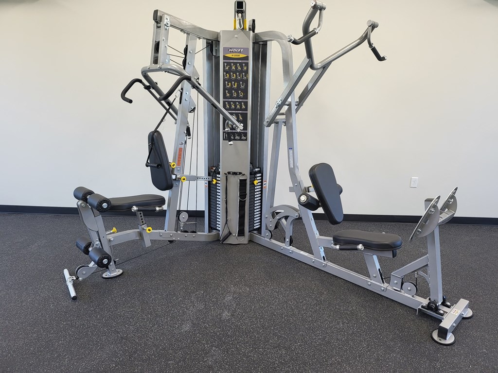 a gym set up with weights and cardio equipment