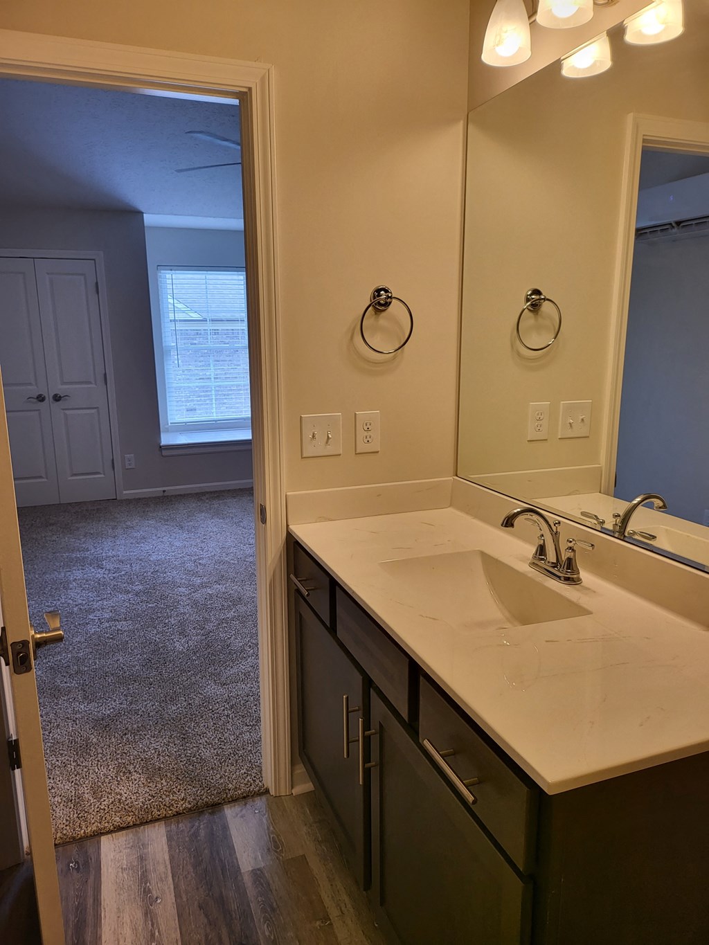 an empty bathroom with a sink and a mirror