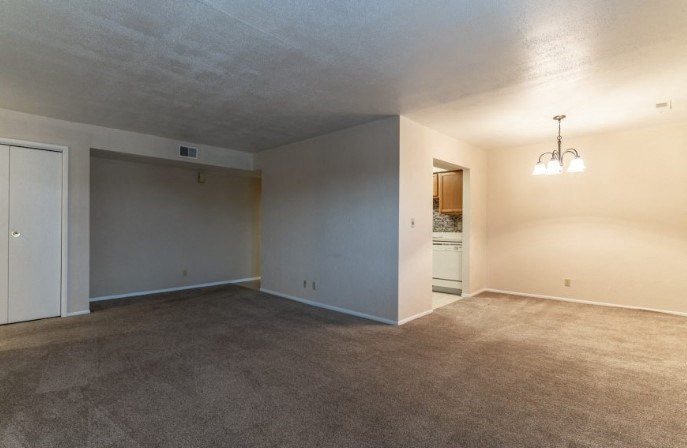 an empty living room and kitchen in a house