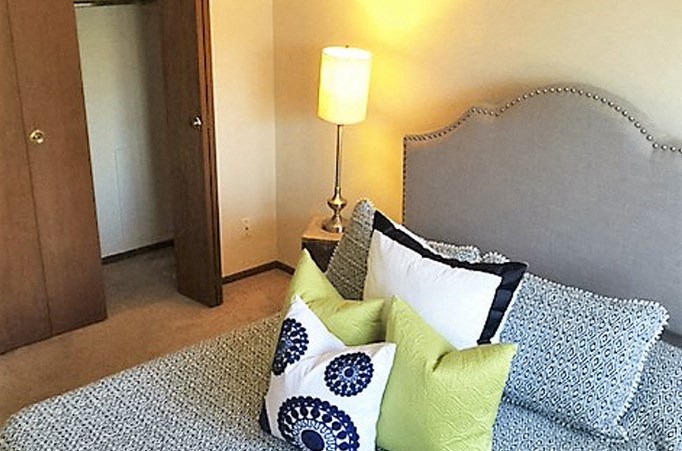 a bedroom with a bed and a lamp