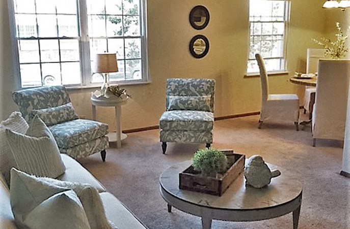 a living room with couches and chairs and a table