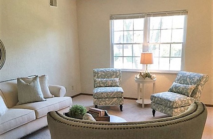 a living room with a couch and two chairs