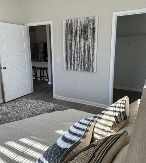 a bedroom with a bed and a painting on the wall