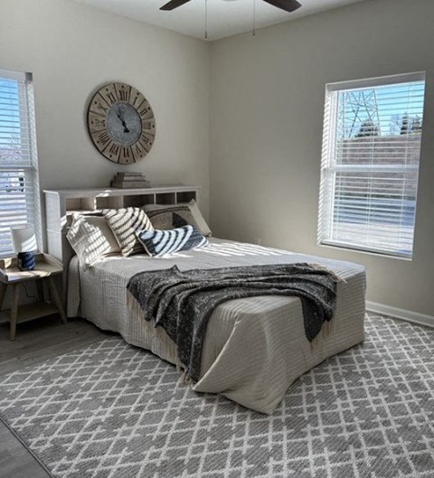 a bedroom with a bed and a clock on the wall