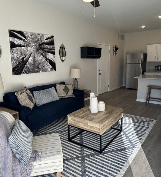 a living room with a blue couch and a coffee table