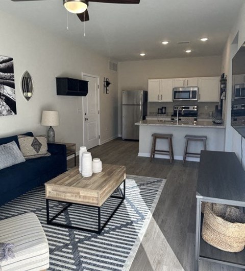 a living room with a kitchen and a table