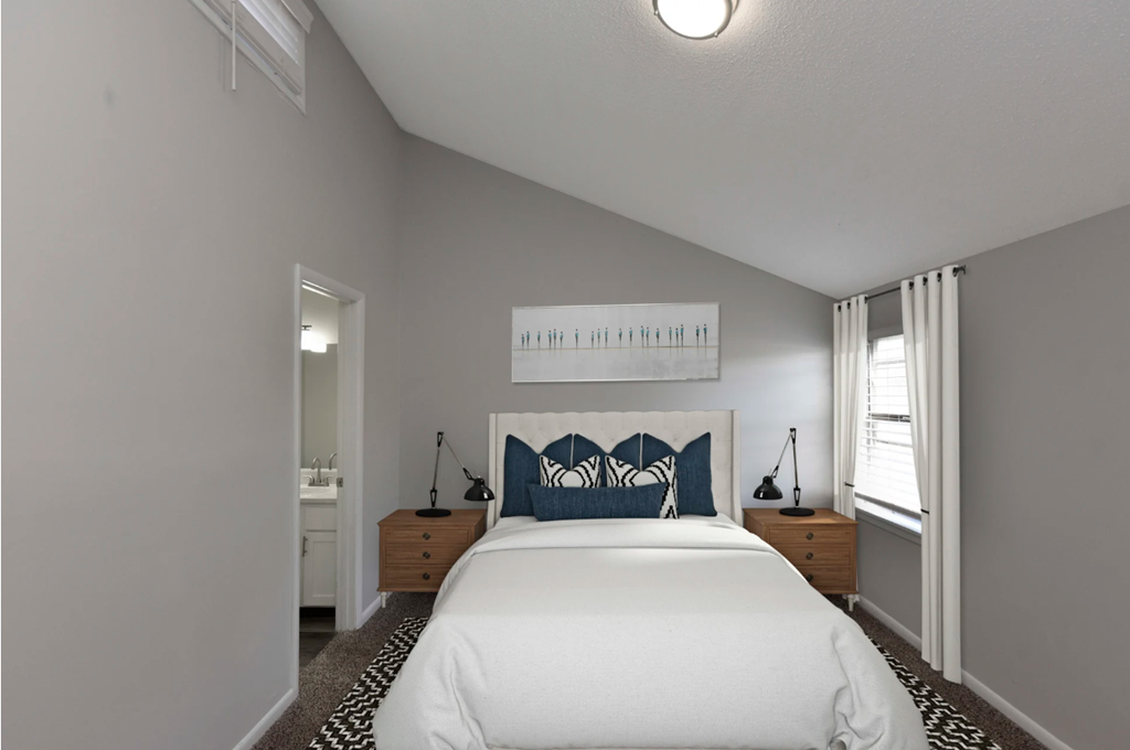 a bedroom with a large bed and a window