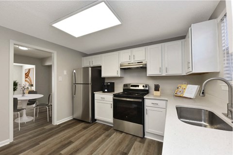 a kitchen with white cabinets and stainless steel appliances