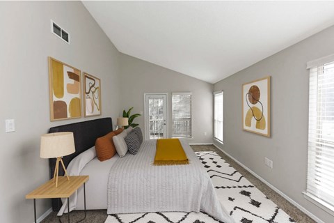 a bedroom with a large bed and some pictures on the wall