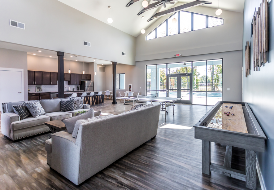 A spacious living room with a pool table and a view of the outdoors.