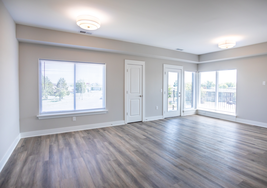 A room with wooden floors and a large window.