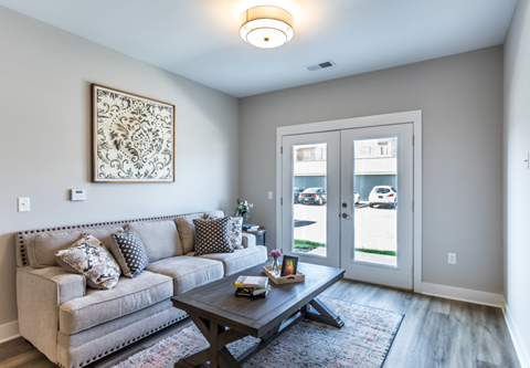 A living room with a grey couch and a coffee table.