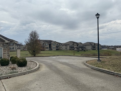the view of an empty street in a subdivision with houses
