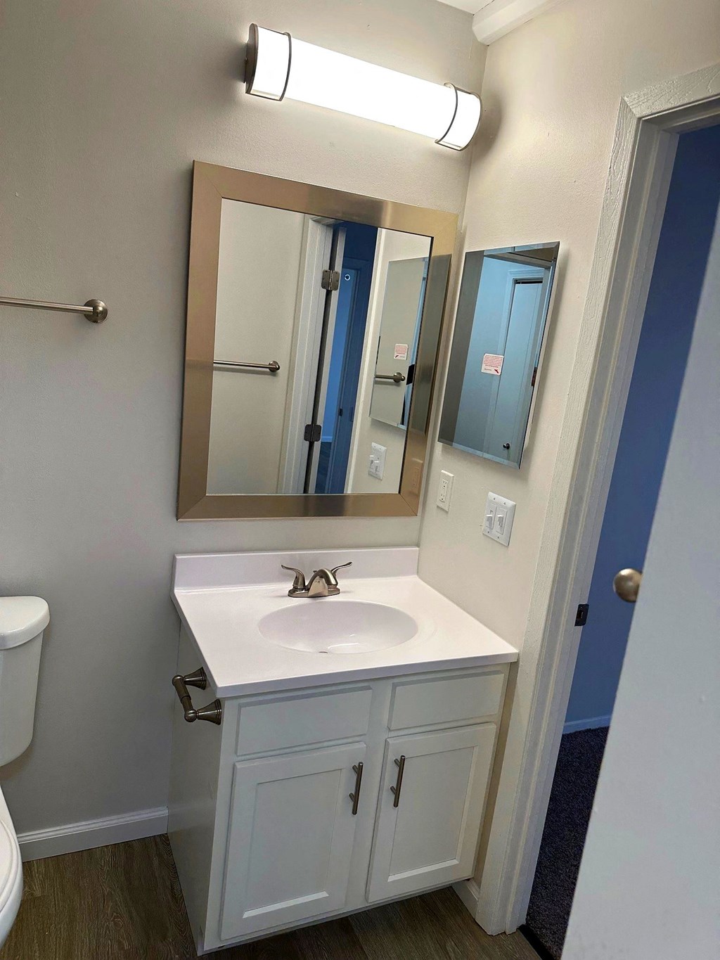 a small bathroom with a sink and mirror