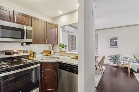 A kitchen with a stove top oven and a dishwasher.