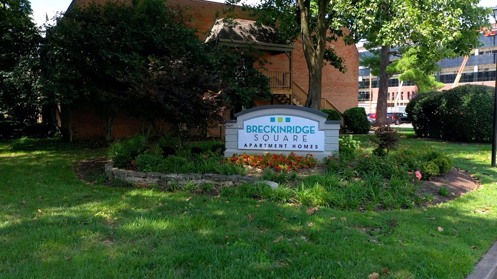 a sign in the front yard of a building