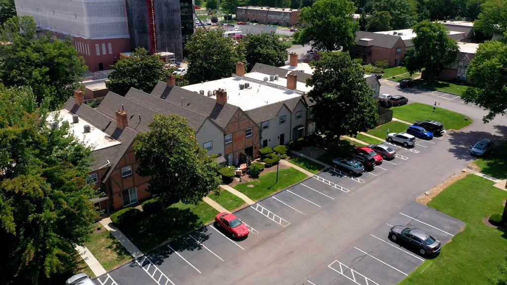 an aerial view of a neighborhood with cars parked in a parking lot