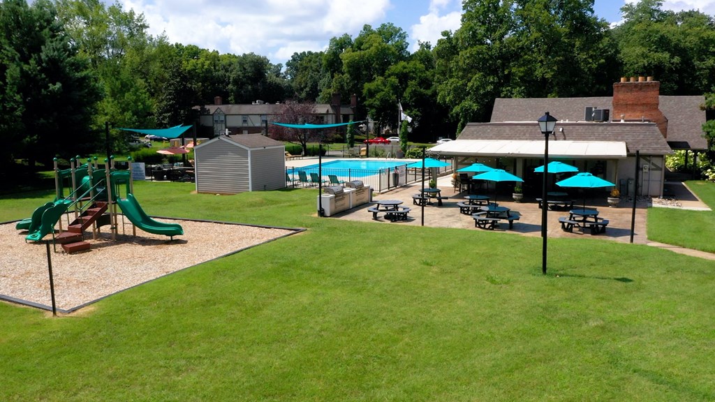 a backyard with a playground and a swimming pool