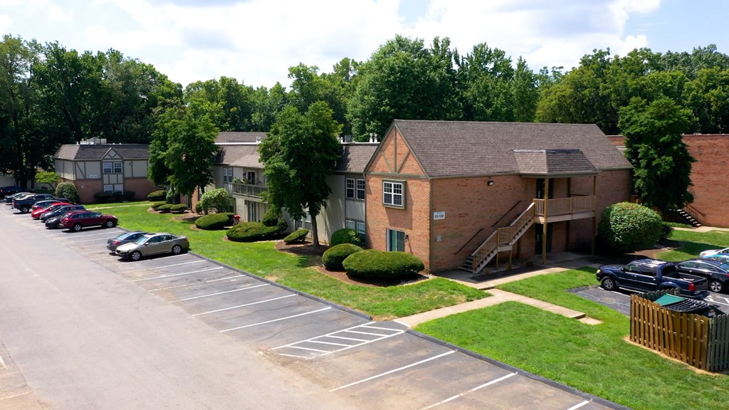 an aerial view of an apartment complex with a parking lot