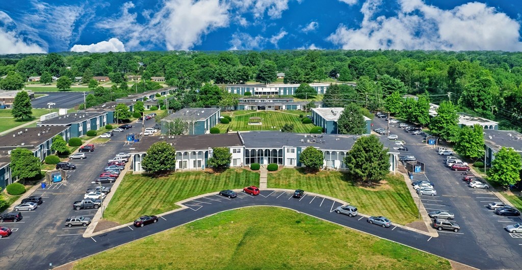A large building with a parking lot in front of it.