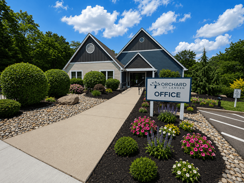 The Orchard of Landen office is surrounded by a well-manicured garden.