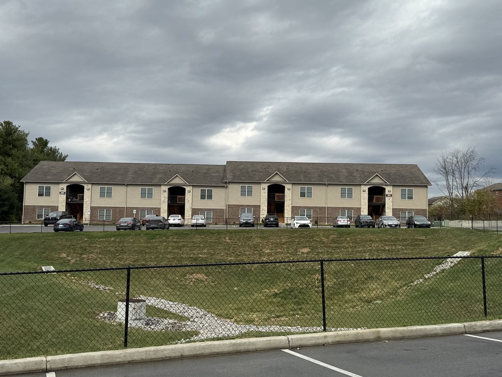 a large building with cars parked in front of it