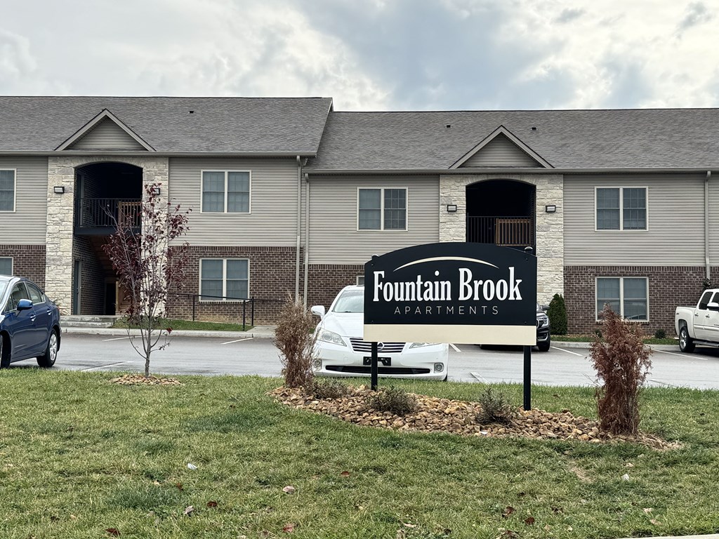 the fountain brook apartments sign in front of the building