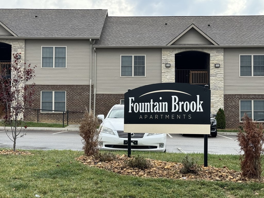 a sign that reads foundation brook apartments in front of a house