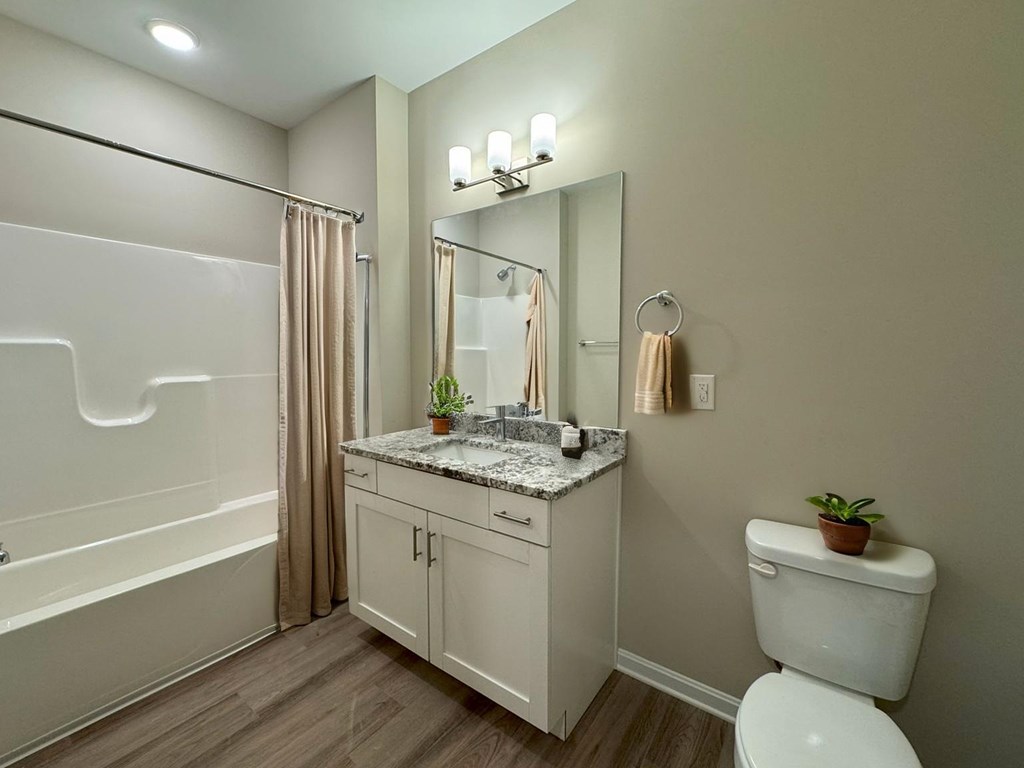 A white toilet sits next to a sink in a bathroom.