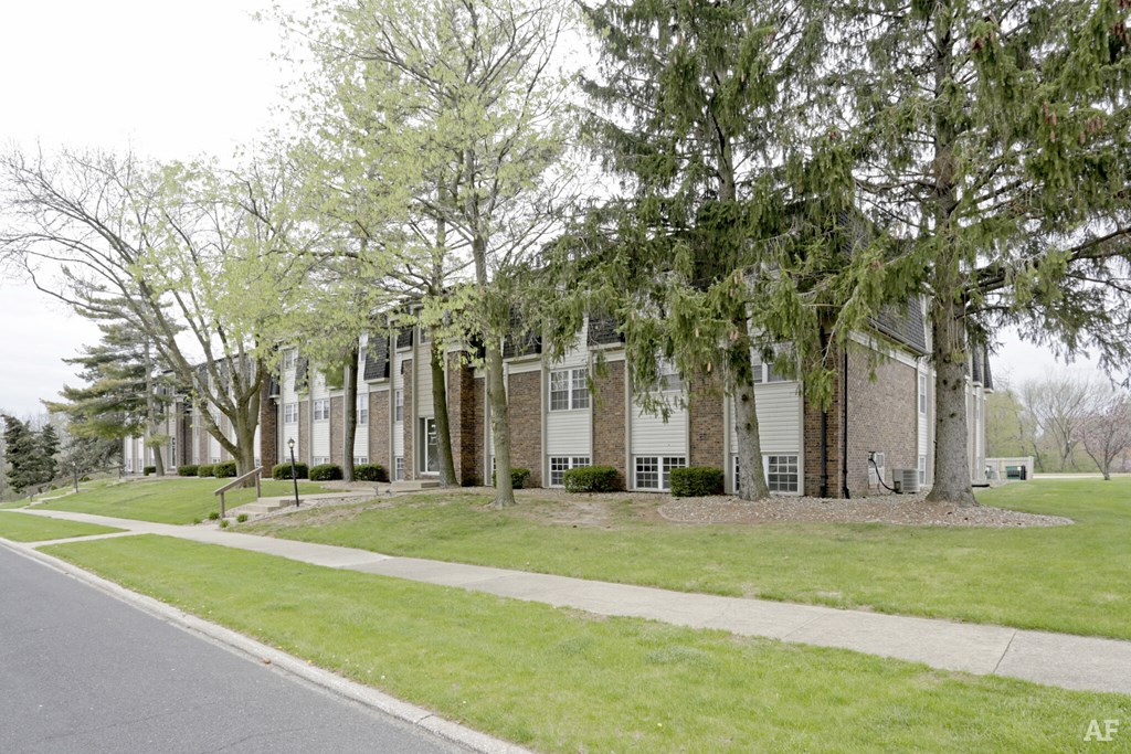 a row of houses with trees in front of them