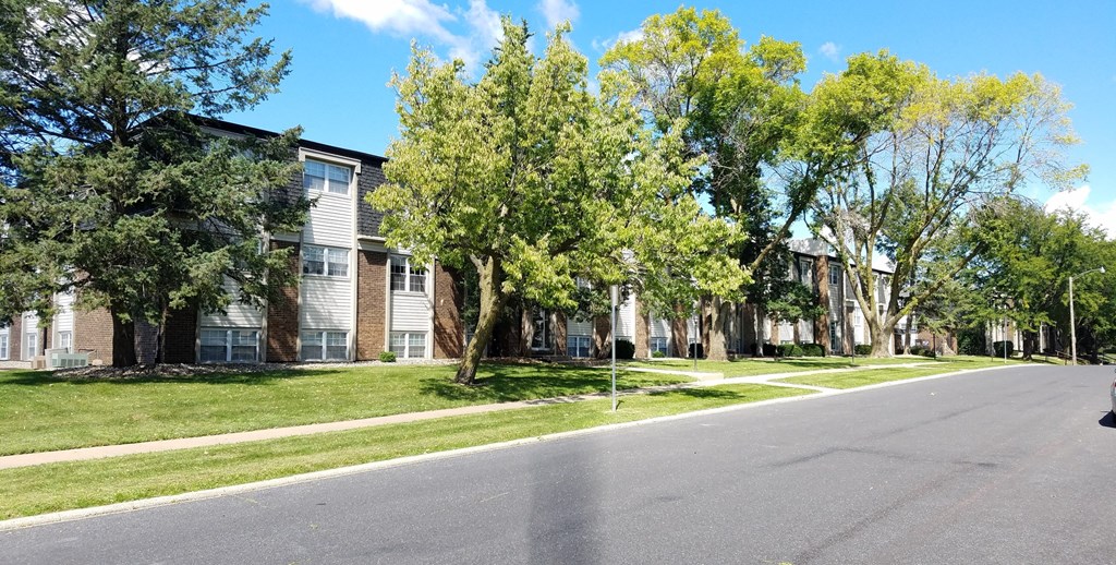 a row of apartment buildings on the side of a street