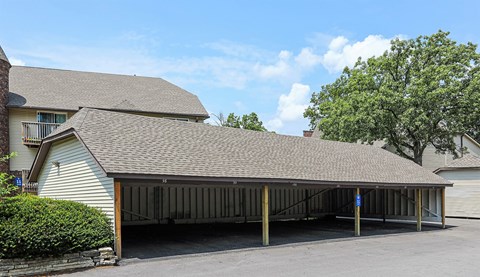 A large building with a covered parking area in front.