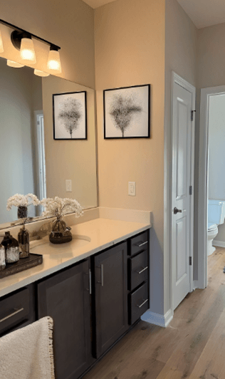 A bathroom with a white towel hanging on a counter.