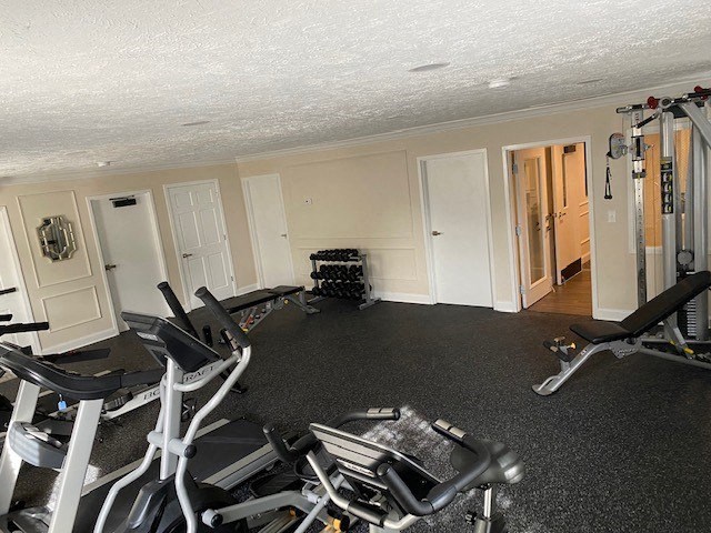 a gym room with exercise equipment in it