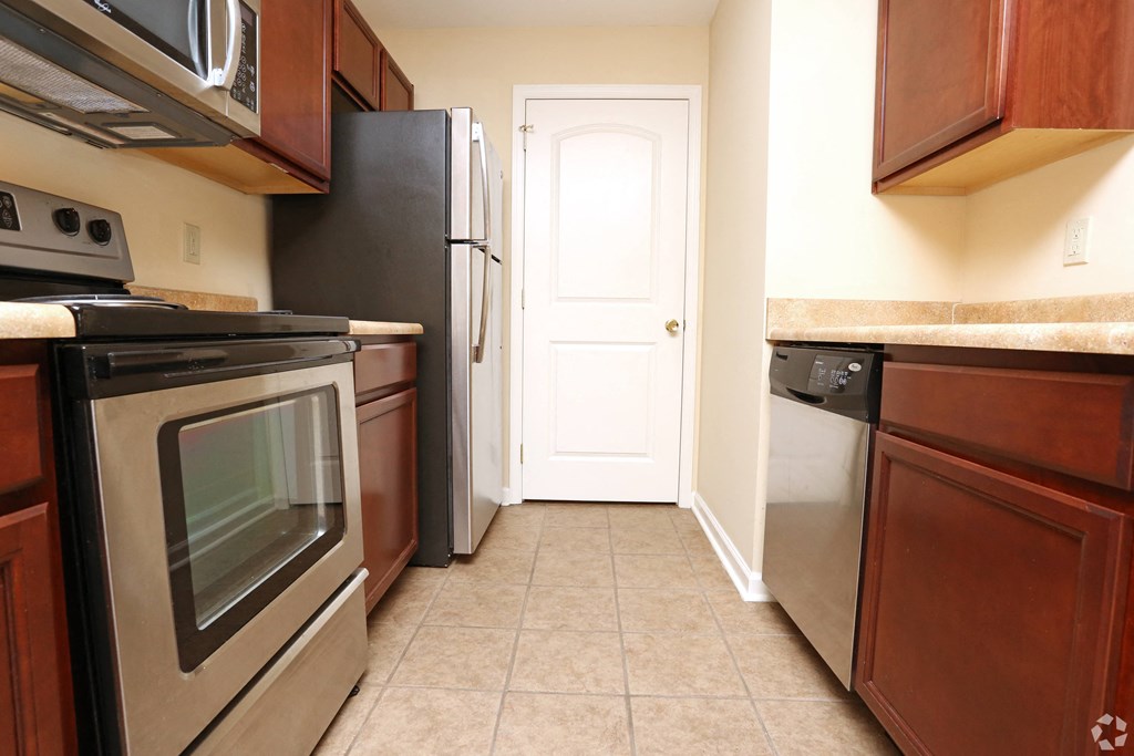 a kitchen with stainless steel appliances and wooden cabinets