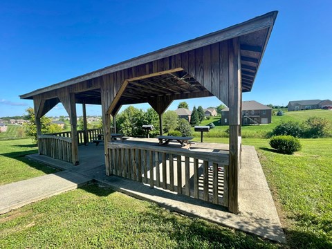 a pavilion with a picnic table in a park