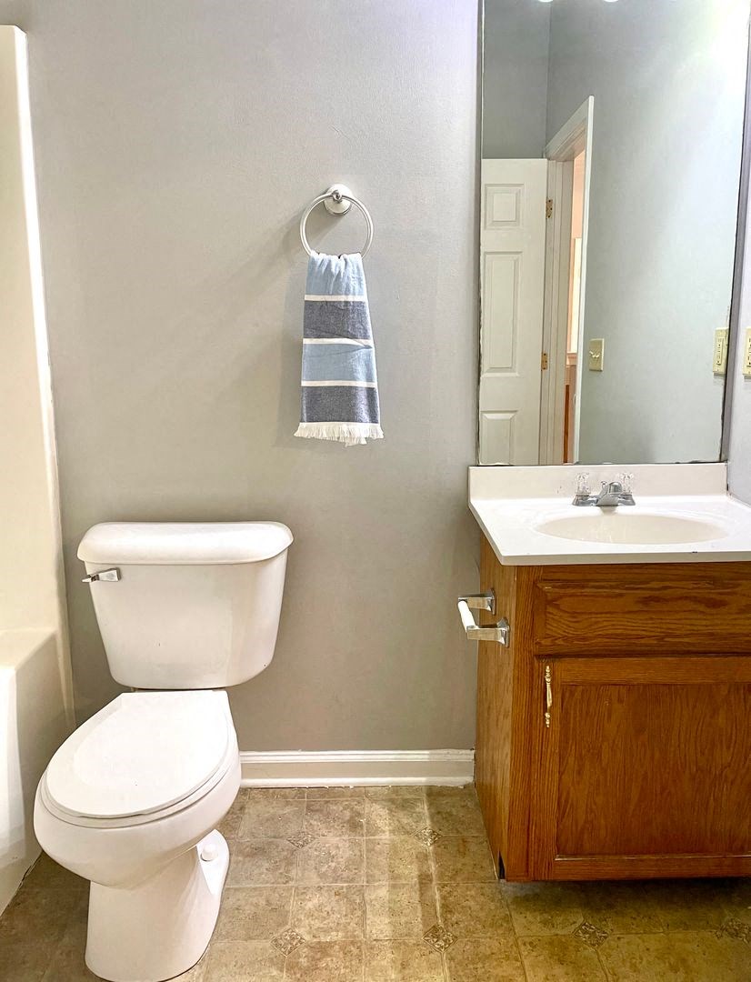 a bathroom with a toilet sink and a mirror