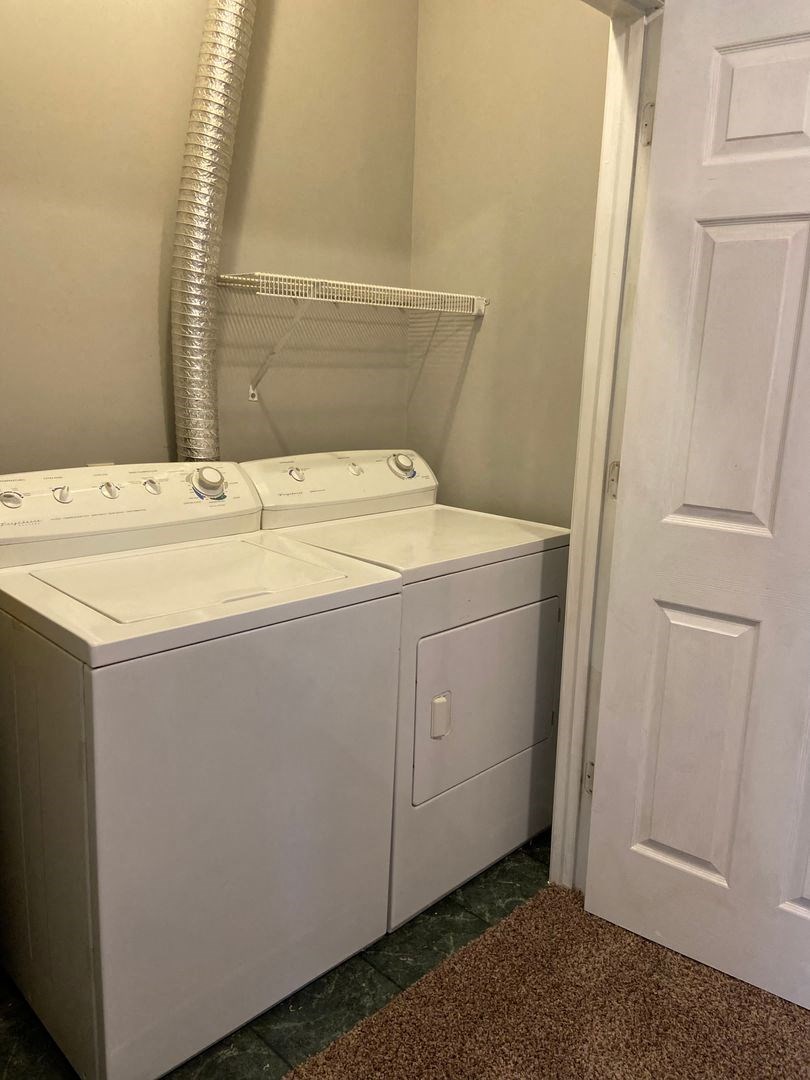 a white washer and dryer in a room with a closet