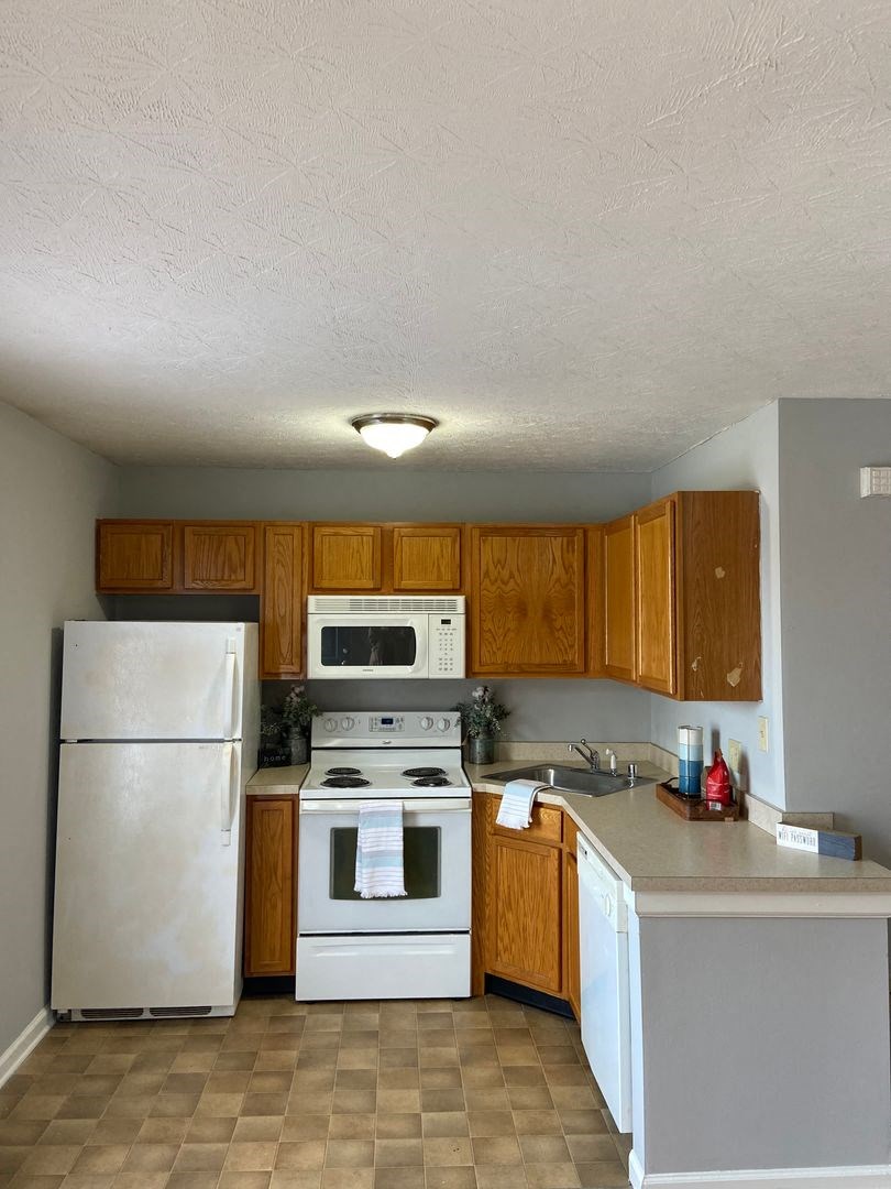 a kitchen with a stove microwave and refrigerator