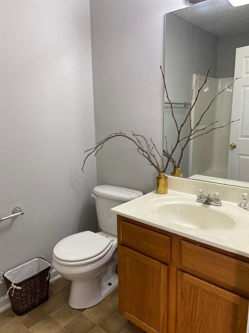 a bathroom with a toilet and a sink and a mirror