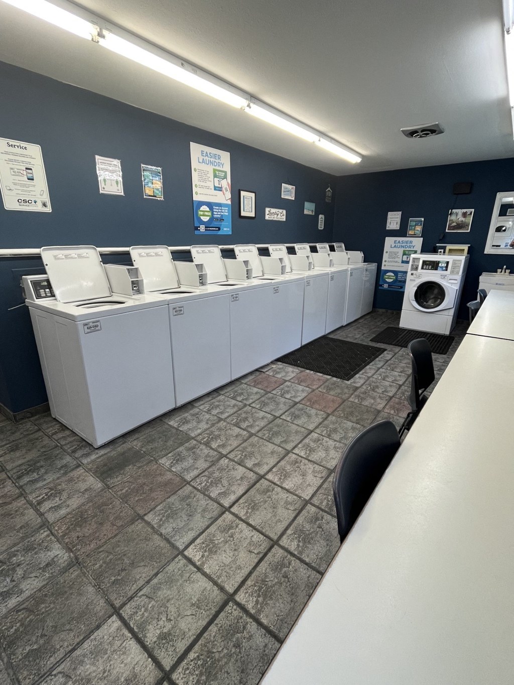 a row of washing machines in a laundry room