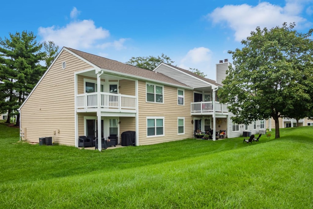 A two-story house with a balcony on the second floor.