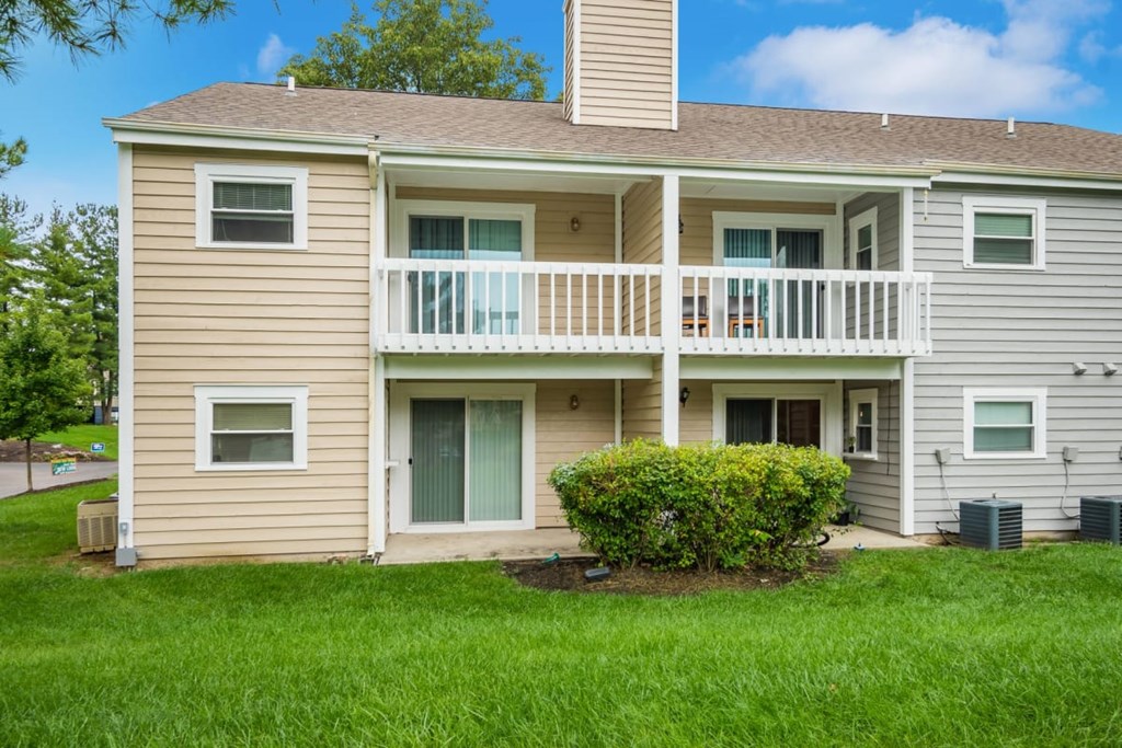 A two-story house with a balcony on the second floor.